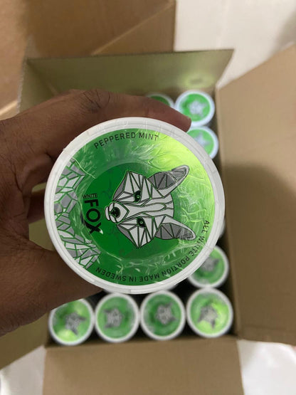Green container with a fox design held by a hand, with more containers in the background