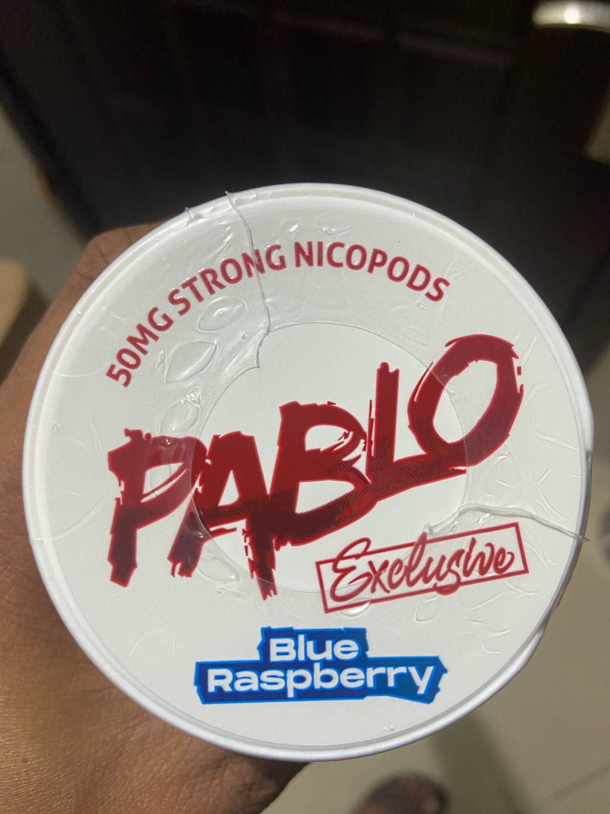 Pablo Nicotine Pouches Blue Raspberry flavor 50mg Strong Nicopods Container held by a hand