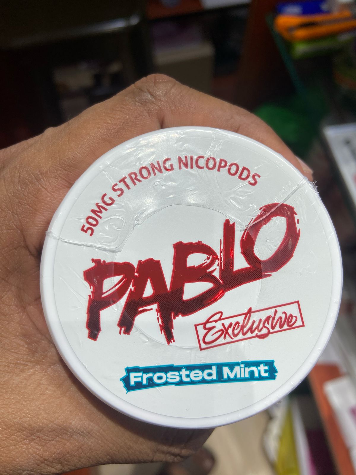 Pablo Nicotine Pouches Frosted Mint flavor 50mg Strong Nicopods Container held by a hand