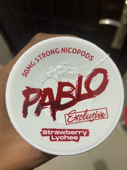 Pablo Nicotine Pouches Strawberry Lychee flavor 50mg Strong Nicopods Container held by a hand